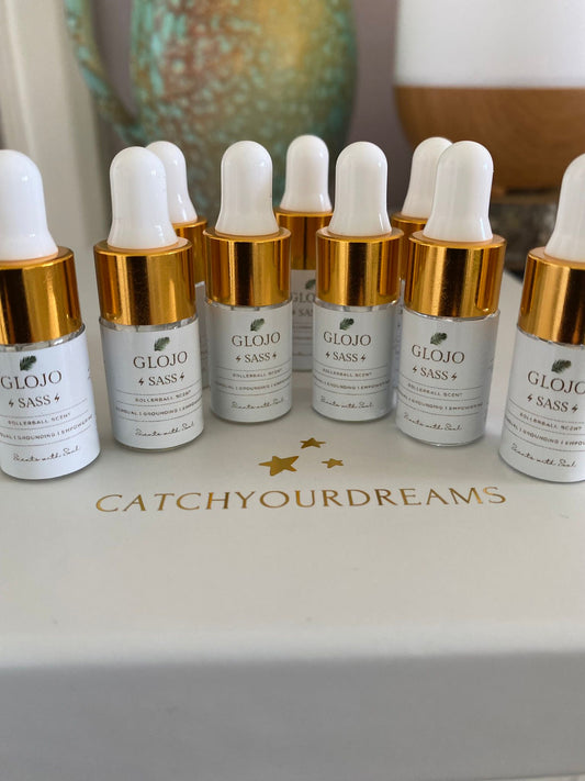 Glojo skincare products on a white surface with 'CatchYourDreams' branding.